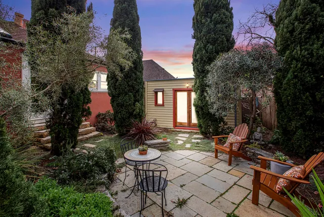 a backyard of a house with outdoor seating