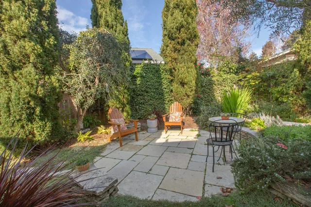 a view of a backyard with sitting area