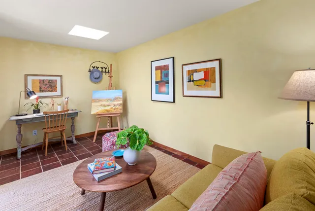 a sign of golf club on a wall under a tree