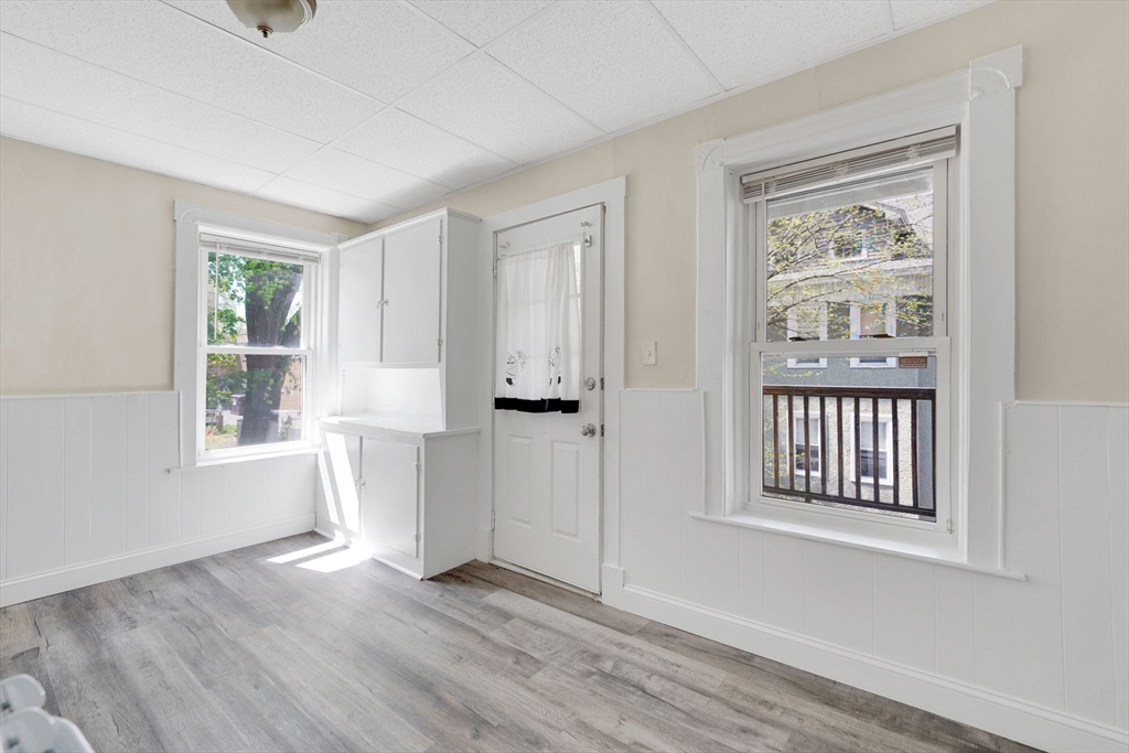 242 Fort Pleasant Avenue Springfield, MA 01108 - Photo 11 of 42 a view of an empty room with a window and wooden floor