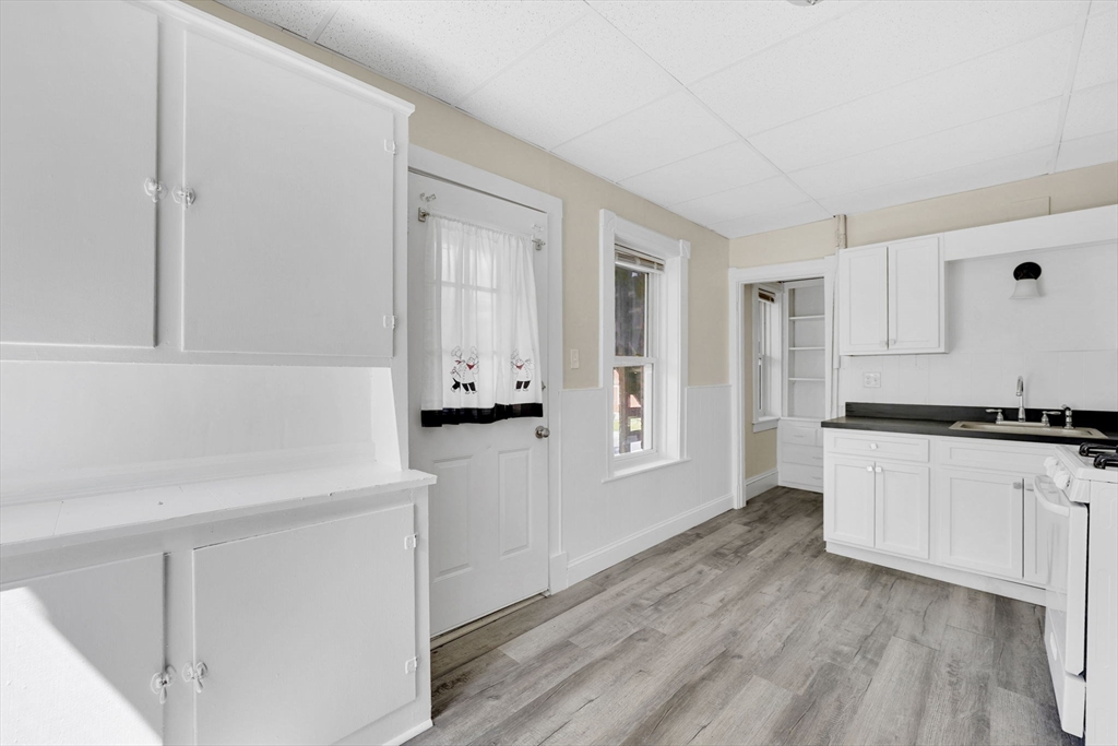 242 Fort Pleasant Avenue Springfield, MA 01108 - Photo 12 of 42 a kitchen with granite countertop white cabinets and white appliances