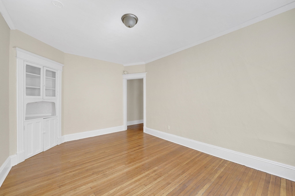 242 Fort Pleasant Avenue Springfield, MA 01108 - Photo 13 of 42 an empty room with wooden floor and windows