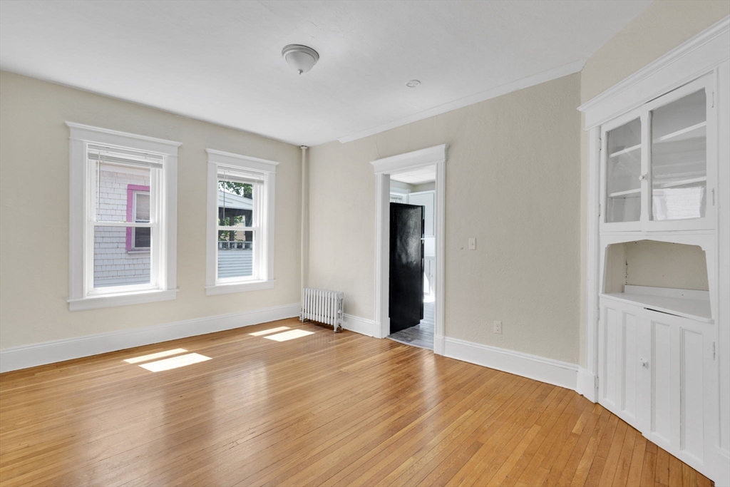 242 Fort Pleasant Avenue Springfield, MA 01108 - Photo 15 of 42 a view of an empty room with wooden floor and a window