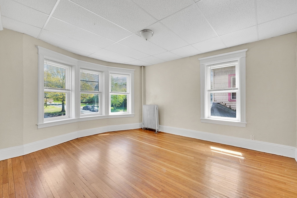 242 Fort Pleasant Avenue Springfield, MA 01108 - Photo 25 of 42 a view of an empty room with wooden floor and a window