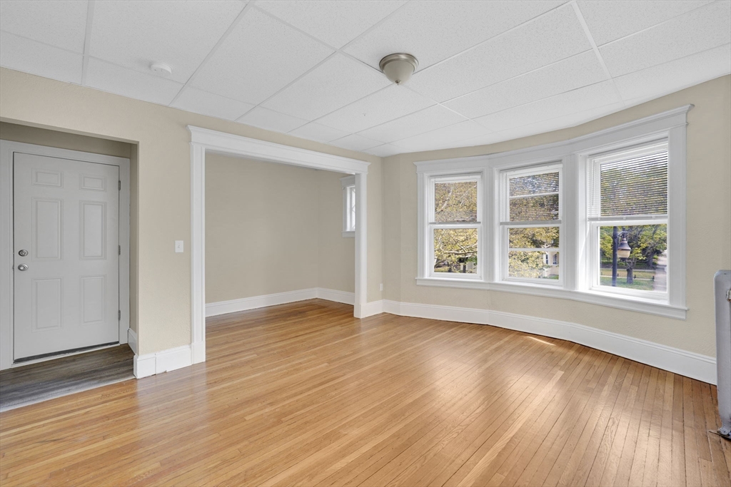 242 Fort Pleasant Avenue Springfield, MA 01108 - Photo 26 of 42 a view of an empty room with wooden floor and a window