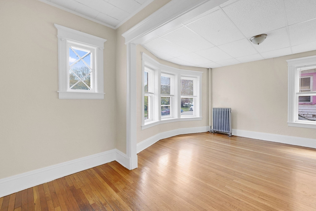 242 Fort Pleasant Avenue Springfield, MA 01108 - Photo 29 of 42 a view of an empty room with window and wooden floor