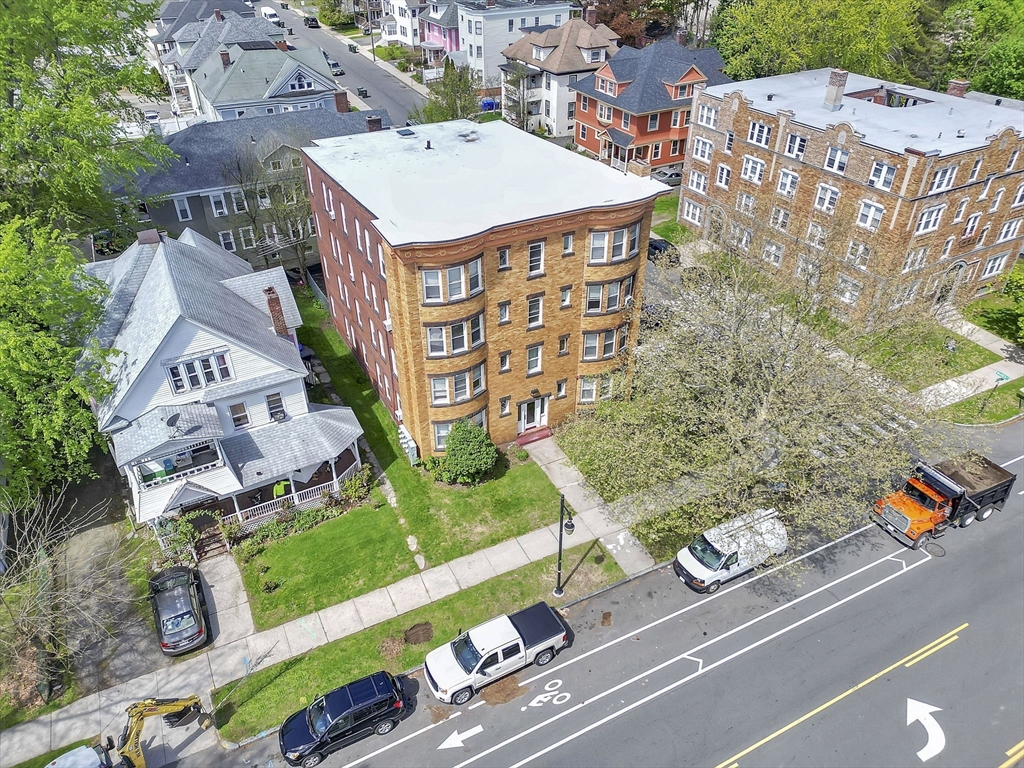 242 Fort Pleasant Avenue Springfield, MA 01108 - Photo 35 of 42 an aerial view of a residential apartment building with a yard and parking spaces