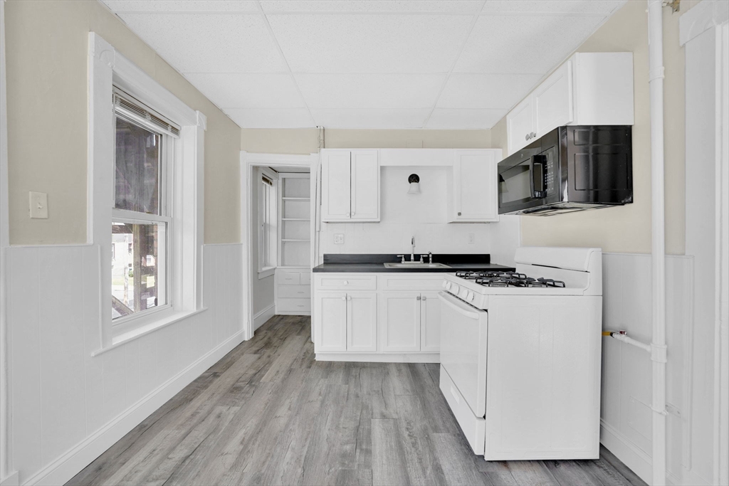 242 Fort Pleasant Avenue Springfield, MA 01108 - Photo 10 of 42 a kitchen with stainless steel appliances a refrigerator and a stove top oven