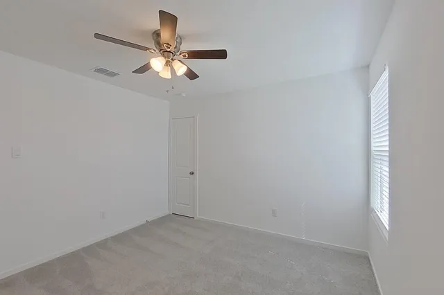 a view of room with window and ceiling fan