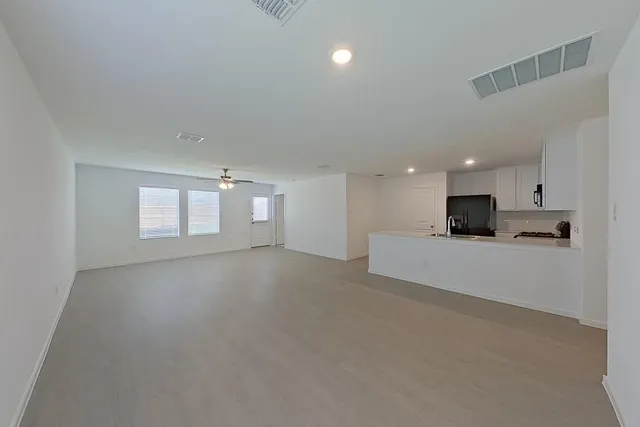 a view of a kitchen with a sink and a stove top oven