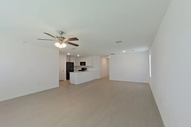 a view of a livingroom and a chandelier fan