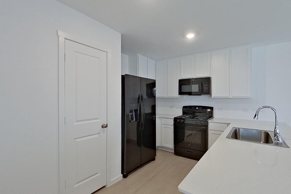 2908 Yellow Pine Avenue Fort Worth, TX 76179 - Photo 4 of 23 a kitchen with stainless steel appliances granite countertop a refrigerator a stove a sink and a microwave