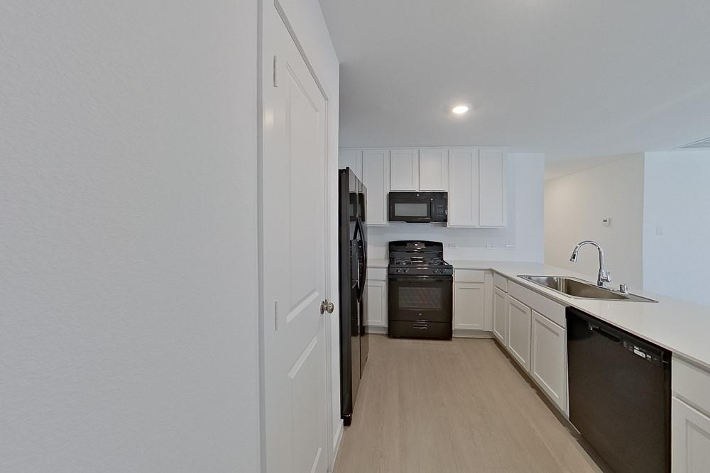 2908 Yellow Pine Avenue Fort Worth, TX 76179 - Photo 5 of 23 a kitchen with a refrigerator sink and stove top oven