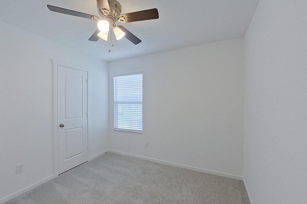 2908 Yellow Pine Avenue Fort Worth, TX 76179 - Photo 9 of 23 an empty room with a chandelier fan and windows