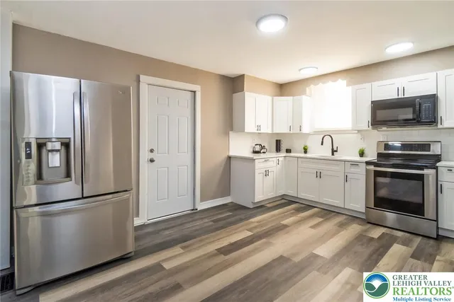 a kitchen with a refrigerator stove and microwave