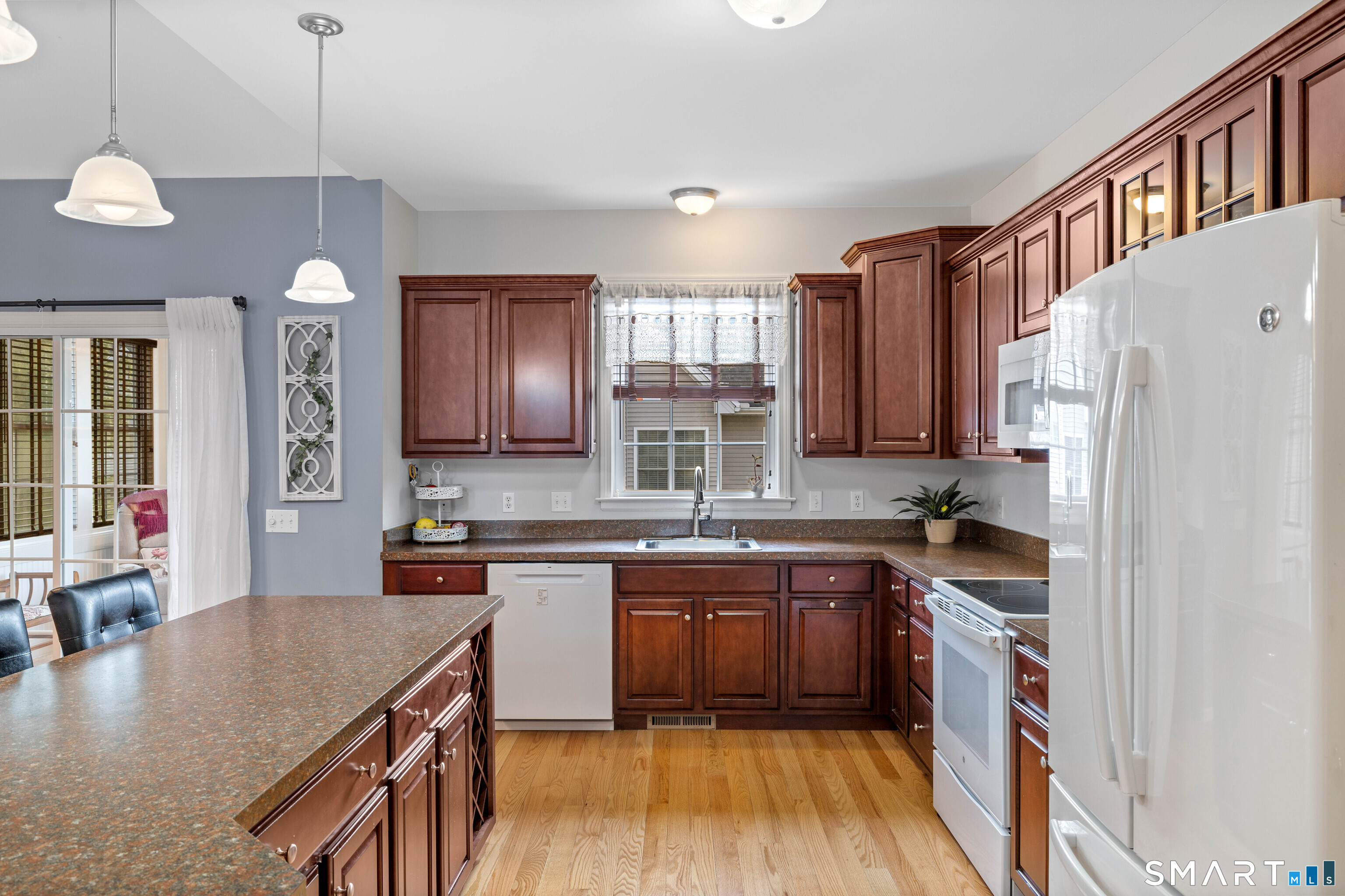 24 Phillips Farm Road, Unit 24 East Hartford, CT 06118 - Photo 17 of 34 a kitchen with stainless steel appliances granite countertop a sink stove and refrigerator