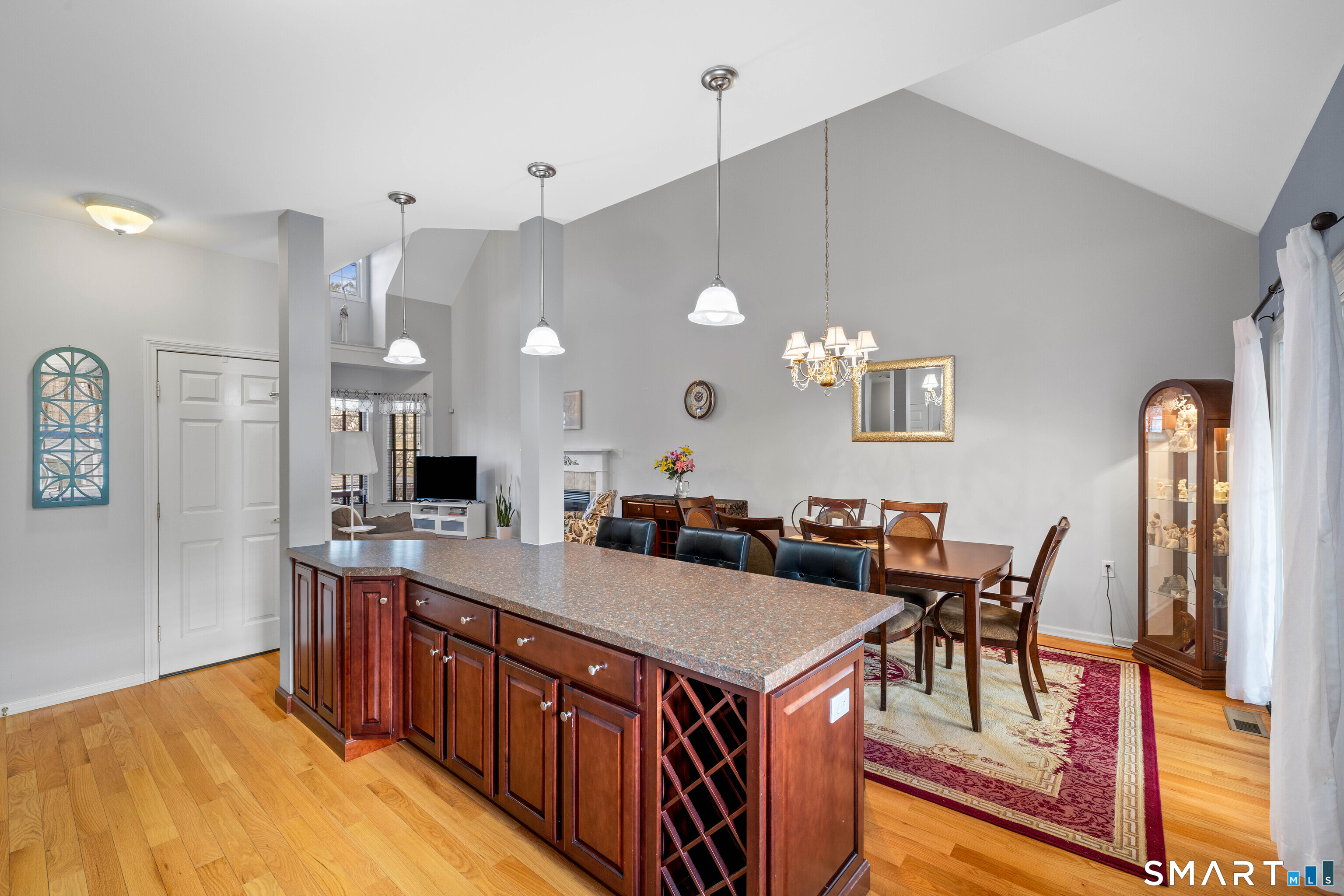 24 Phillips Farm Road, Unit 24 East Hartford, CT 06118 - Photo 19 of 34 a kitchen with stainless steel appliances granite countertop a dining table chairs and a refrigerator