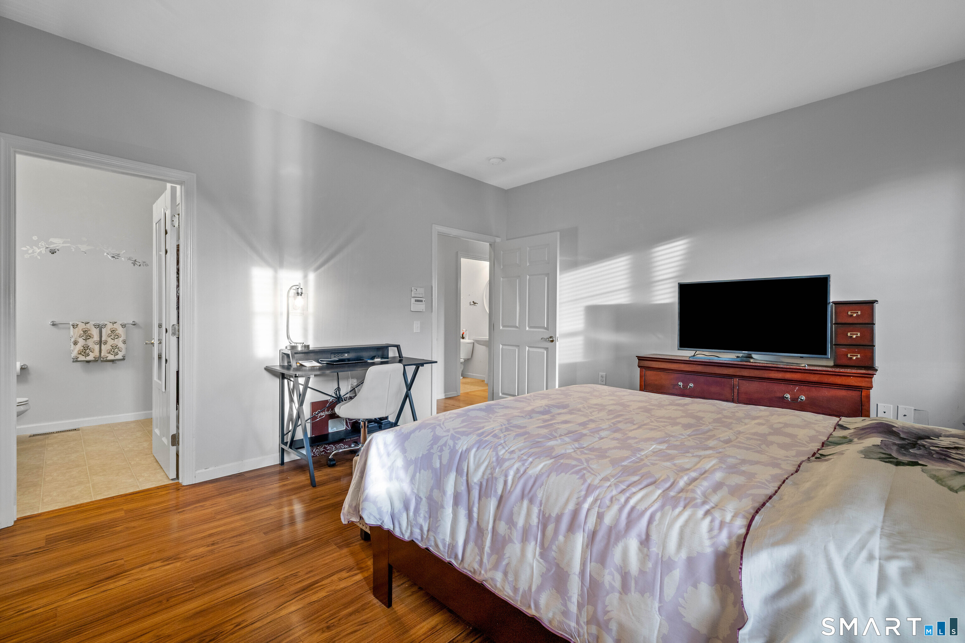 24 Phillips Farm Road, Unit 24 East Hartford, CT 06118 - Photo 24 of 34 a bedroom with a bed and a flat screen tv