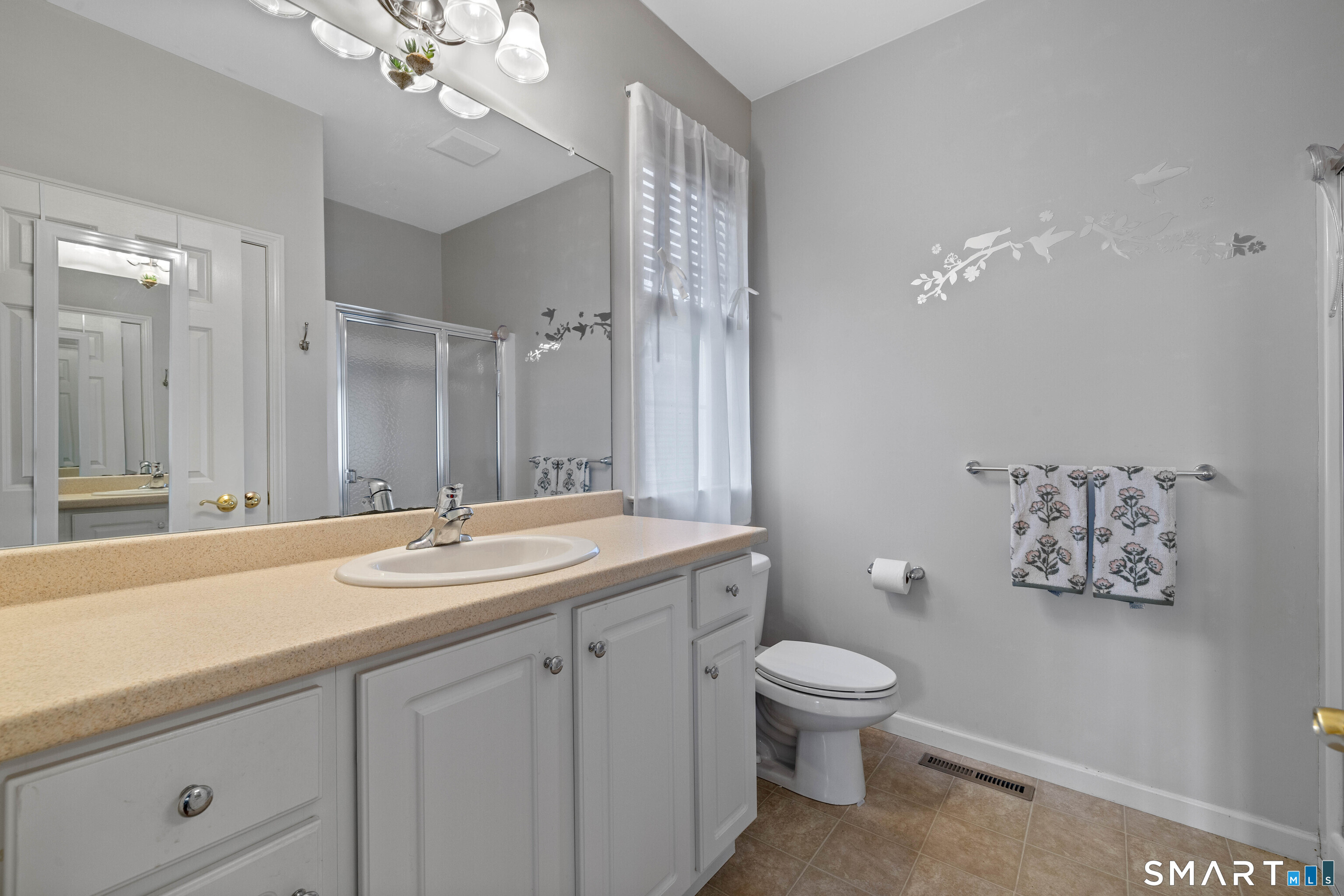 24 Phillips Farm Road, Unit 24 East Hartford, CT 06118 - Photo 25 of 34 a bathroom with a granite countertop sink a toilet and a mirror