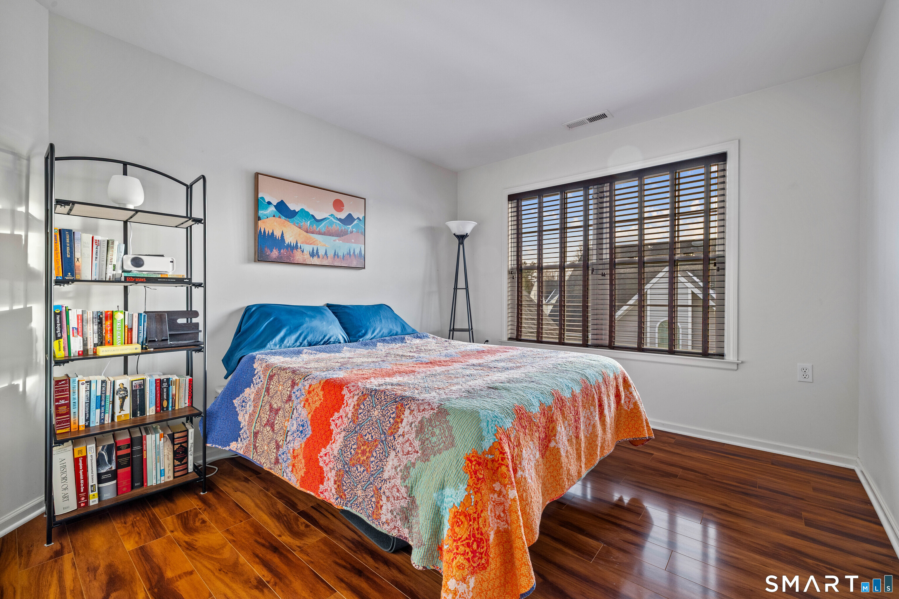 24 Phillips Farm Road, Unit 24 East Hartford, CT 06118 - Photo 27 of 34 a bedroom with a bed and a book shelf
