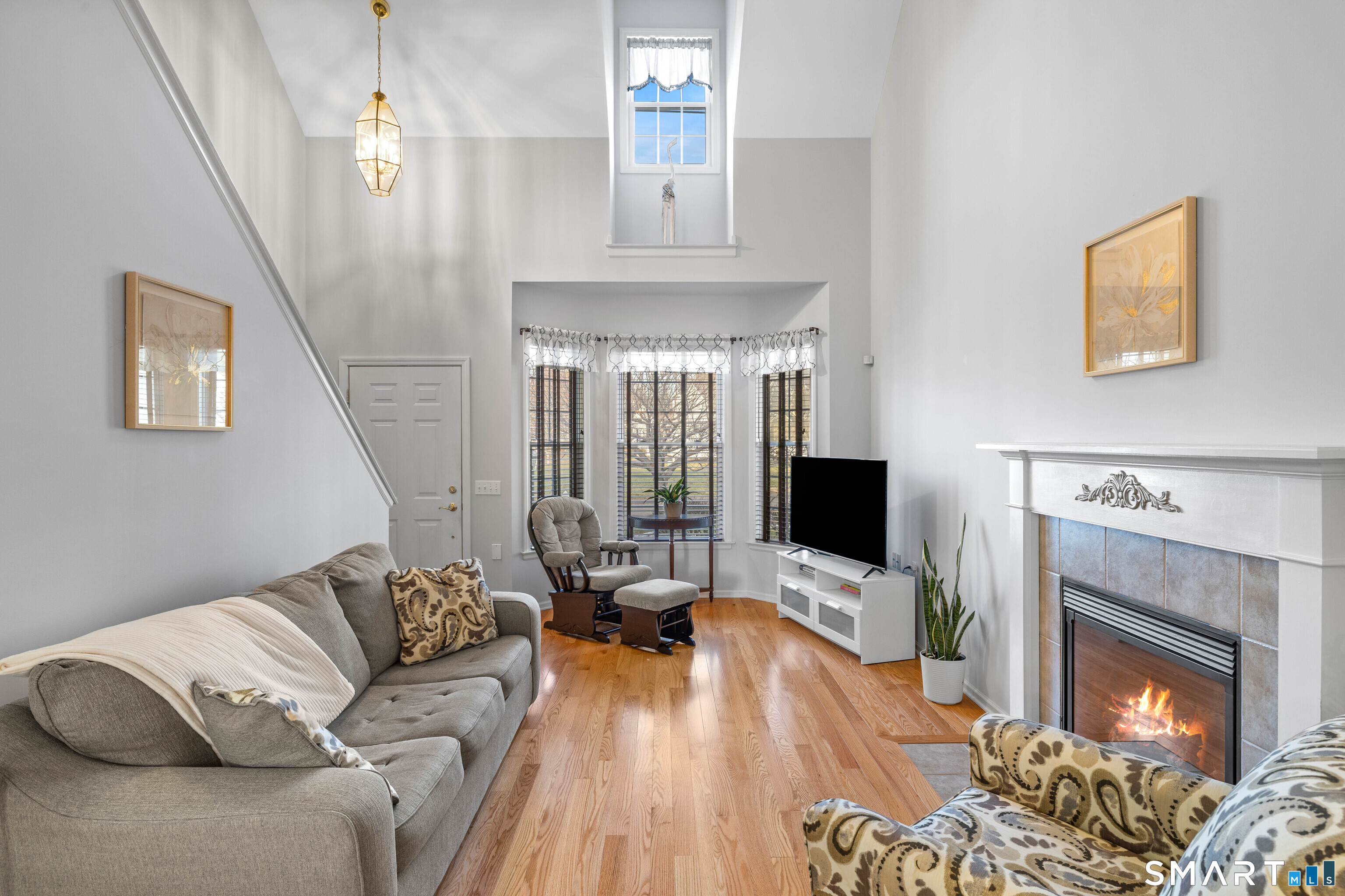 24 Phillips Farm Road, Unit 24 East Hartford, CT 06118 - Photo 6 of 34 a living room with furniture fireplace and flat screen tv