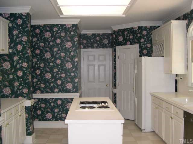 1704 Crown Glenn Place Raleigh, NC 27613 - Photo 3 of 4 a kitchen with a sink a stove and a refrigerator