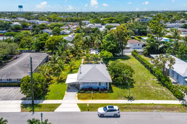 an aerial view of a house with a yard