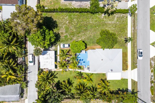 an aerial view of residential houses with outdoor space and street view