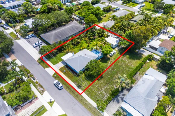 an aerial view of residential houses with outdoor space and street view