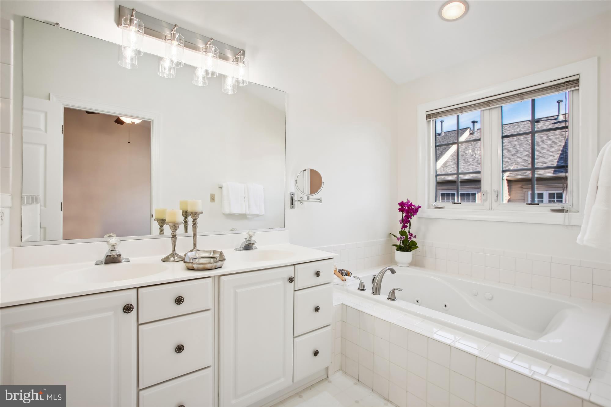 5803 Summers Grove Road Alexandria, VA 22304 - Photo 18 of 43 a bathroom with a tub sink and mirror
