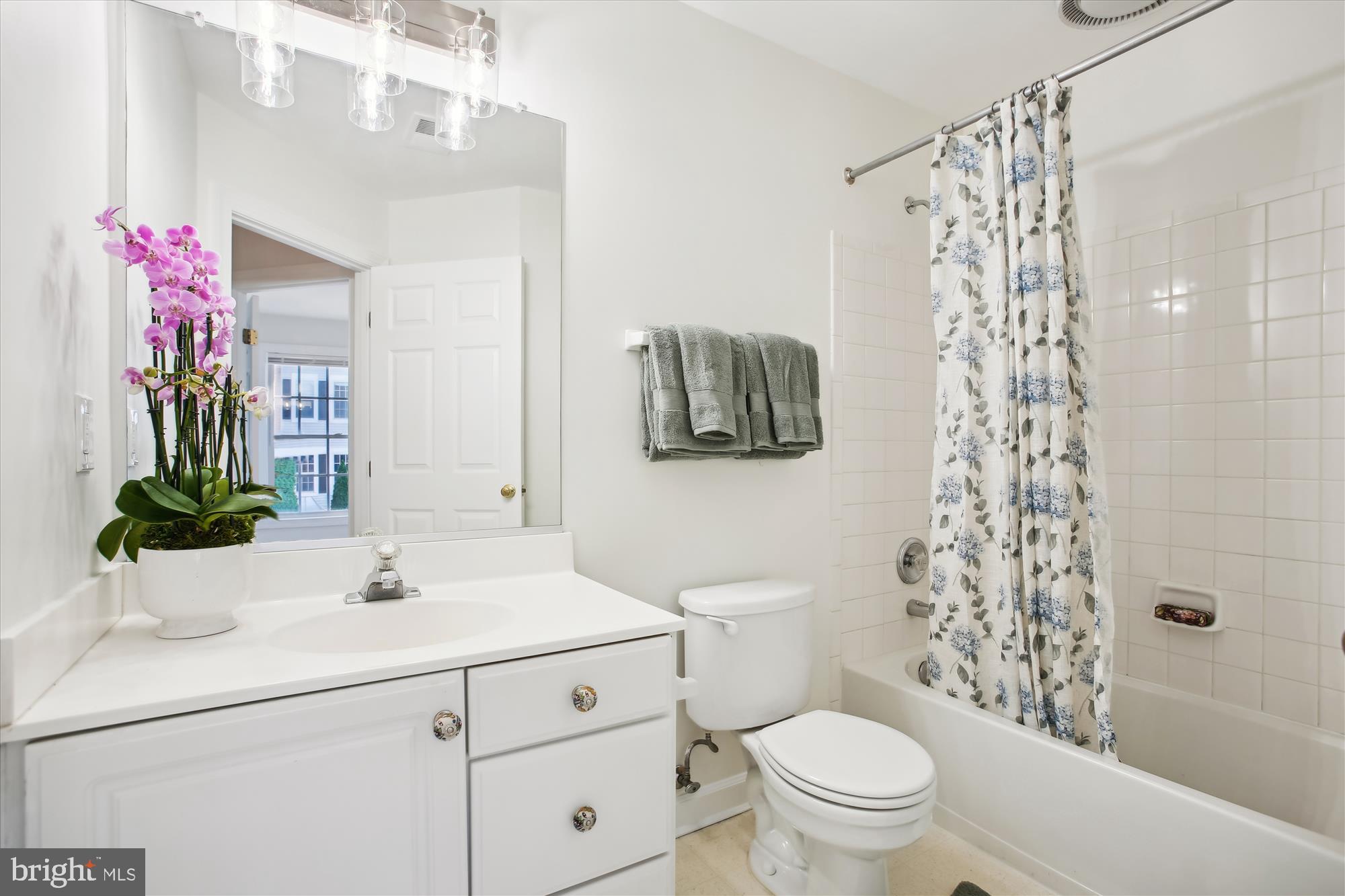5803 Summers Grove Road Alexandria, VA 22304 - Photo 22 of 43 a bathroom with a sink a toilet and shower curtain