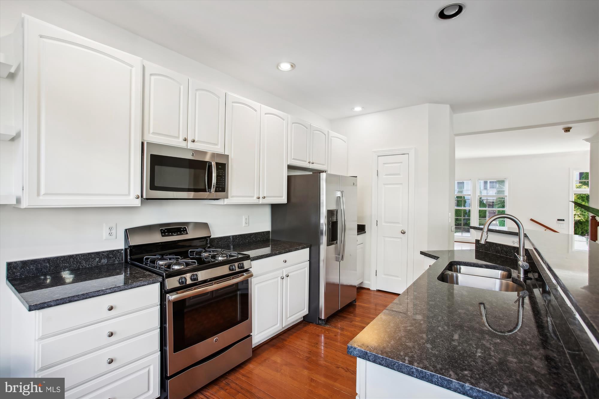 5803 Summers Grove Road Alexandria, VA 22304 - Photo 4 of 43 a kitchen with stainless steel appliances granite countertop a stove a sink and a refrigerator
