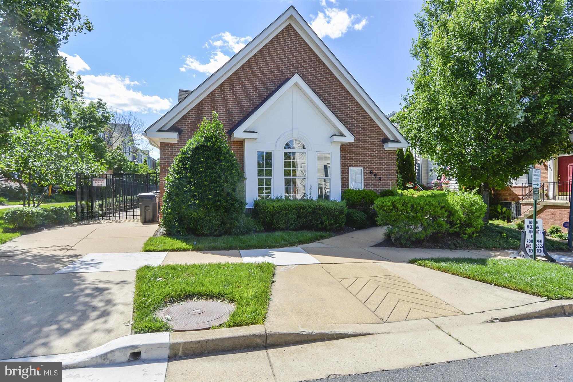 5803 Summers Grove Road Alexandria, VA 22304 - Photo 42 of 43 a front view of a house with a yard and potted plants