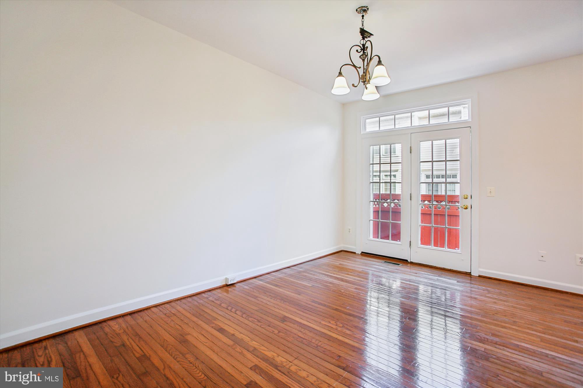 5803 Summers Grove Road Alexandria, VA 22304 - Photo 5 of 43 a view of an empty room with wooden floor and a window