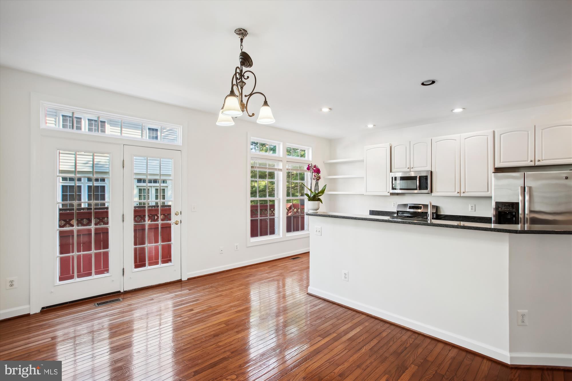 5803 Summers Grove Road Alexandria, VA 22304 - Photo 8 of 43 a large kitchen with stainless steel appliances granite countertop a large counter top and wooden floors