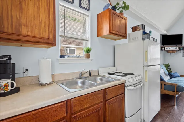 a kitchen that has a sink a stove and a window