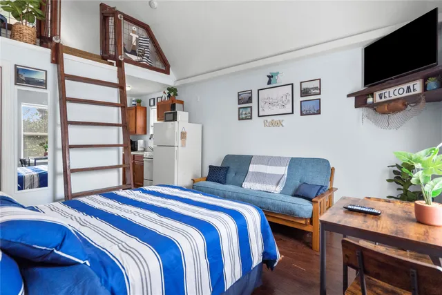 a bedroom with a bed and a tv