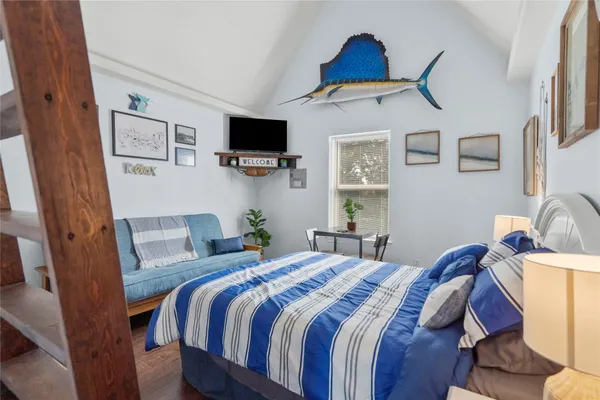 a bedroom with bed and a window