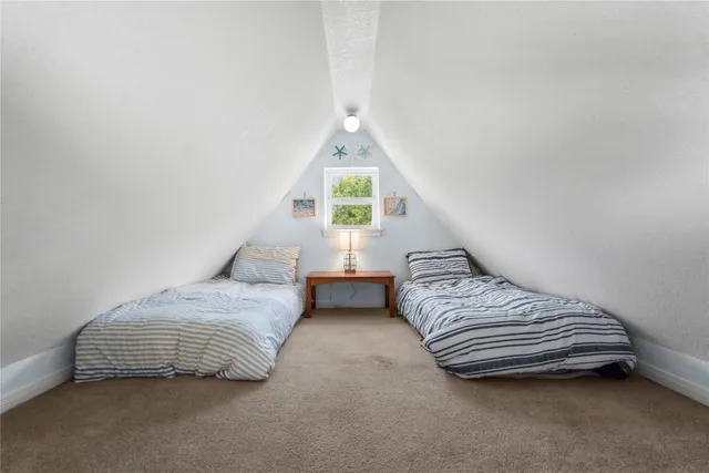 a bedroom with bed and wooden floor