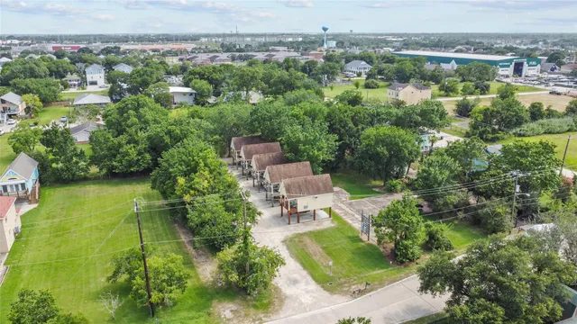 an aerial view of a house with a yard and lake view
