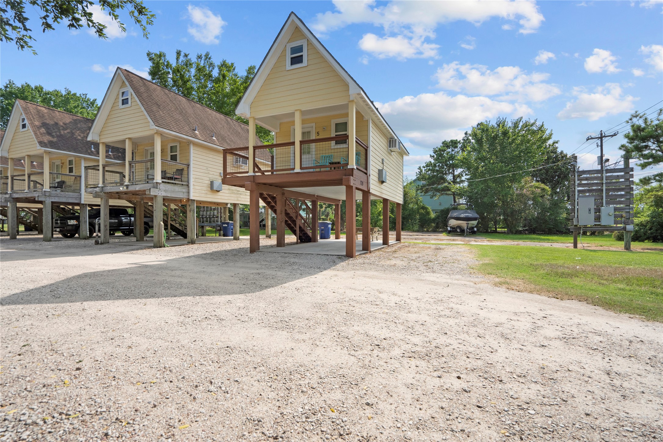 120 Grove Road, Unit 4 Kemah, TX 77565 - Photo 6 of 20 a view of a white house next to a yard with big trees