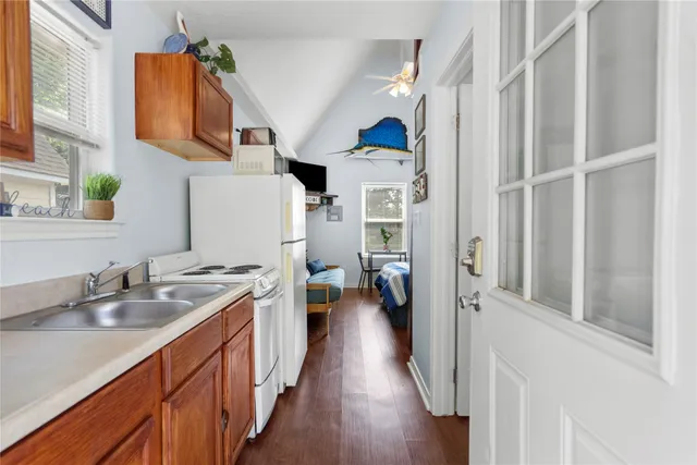 a kitchen with stainless steel appliances granite countertop a sink stove and cabinets