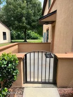 an empty room with wooden floor chandelier and windows