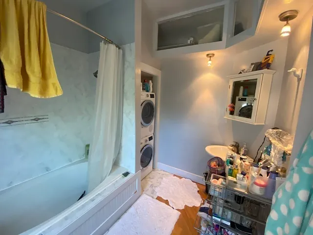 a bathroom with a sink mirror and shower