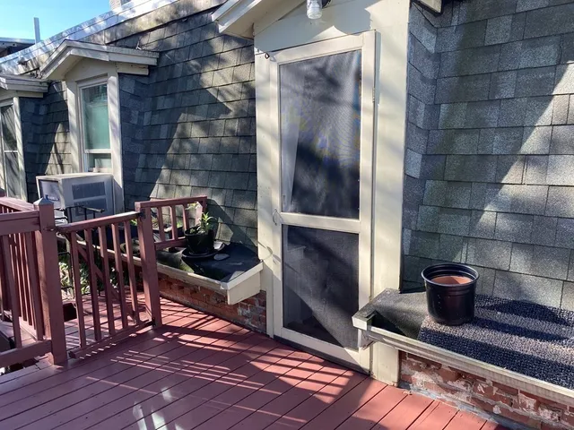 a view of an outdoor space with wooden floor