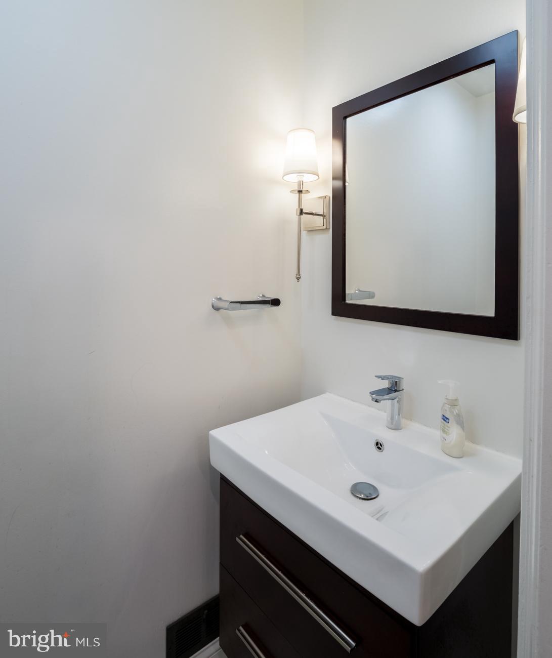 3424 O Street Northwest Washington, DC 20007 - Photo 16 of 29 a bathroom with a sink a mirror and a toilet