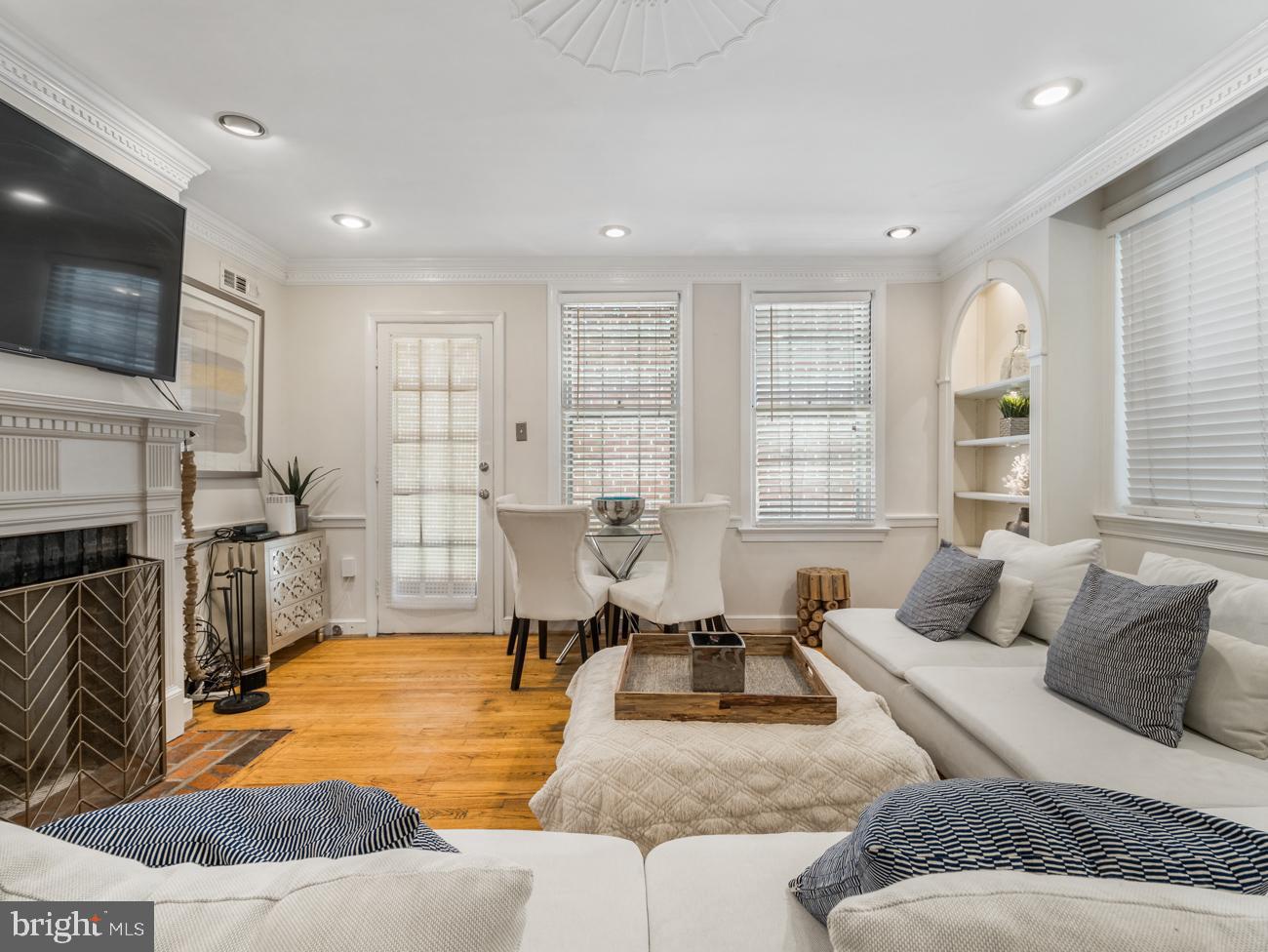 3424 O Street Northwest Washington, DC 20007 - Photo 3 of 29 a living room with furniture fireplace and a flat screen tv