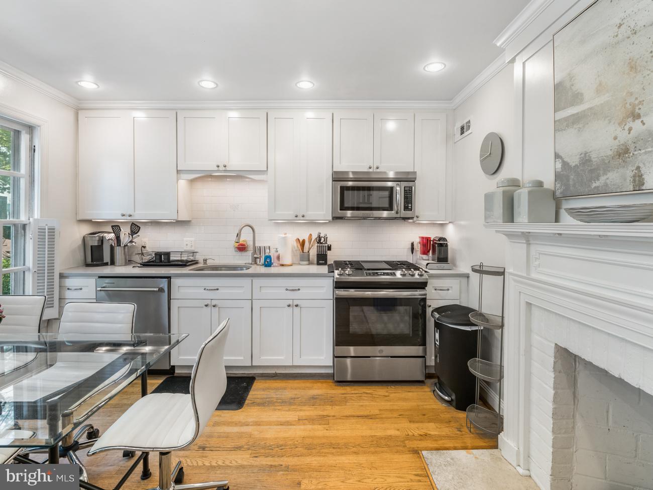3424 O Street Northwest Washington, DC 20007 - Photo 5 of 29 a kitchen with kitchen island granite countertop a stove and a sink