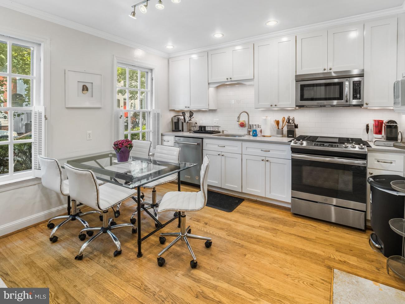 3424 O Street Northwest Washington, DC 20007 - Photo 6 of 29 a kitchen with stainless steel appliances kitchen island granite countertop a sink and cabinets