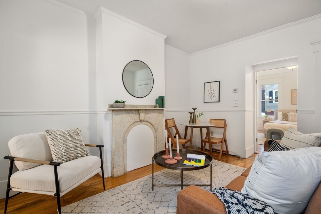 110 Elm Street, Unit 1 Boston, MA 02129 - Photo 2 of 17 a living room with furniture a rug and white walls